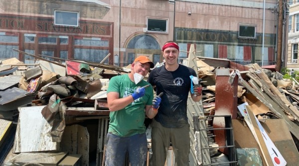 Two Main Streeters work to clean up after a disaster downtown.