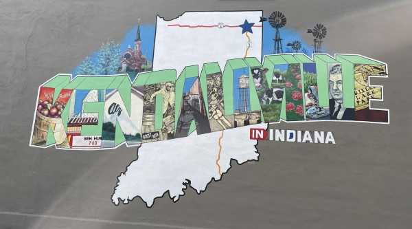 A brightly colored mural on a dark gray wall features the word "Kendallville," where each block letter depicts an image.
