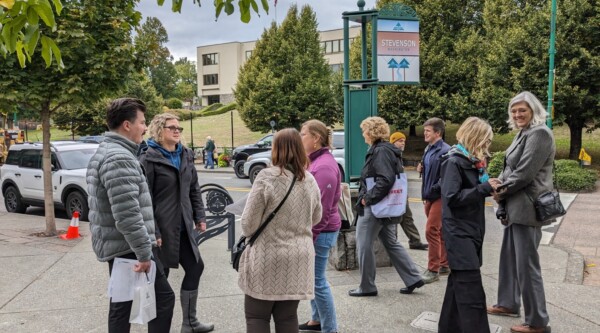 Main Street America staff and Main Street America Institute participants stand on a street corner in Stevenson, Washington.