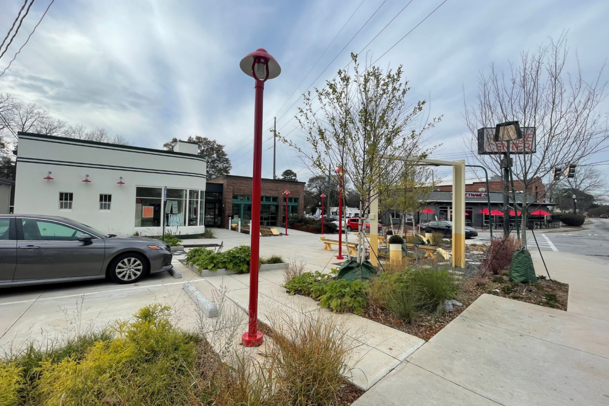 Sidewalk with surrounding landscaping outside of a small business.