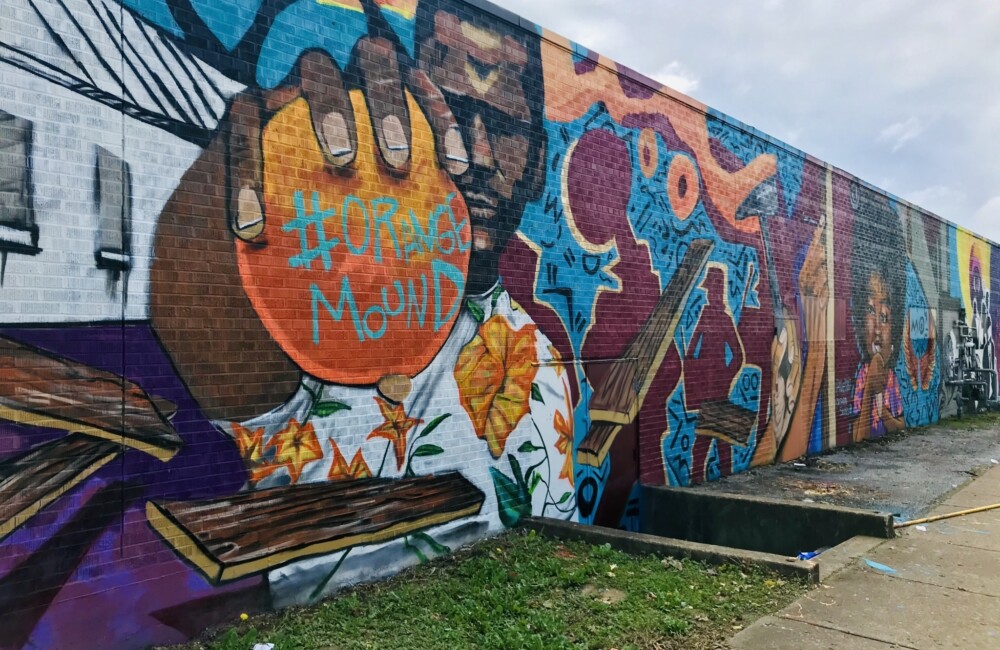 Colorful mural on the side of a building depicting an African American man holding a ball in Memphis, Tennessee.