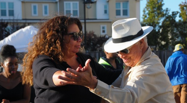 Two people dancing downtown.