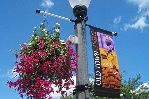 Street banner and flower basket in Old Town Lansing, Michigan.