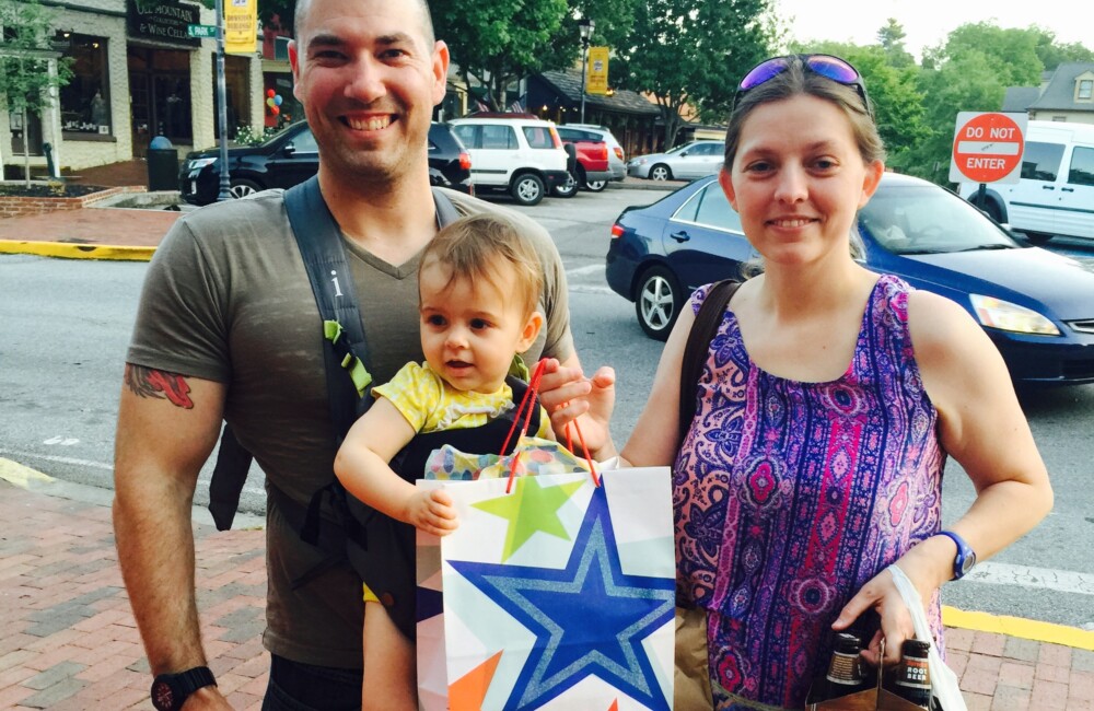 A couple hold shopping bags.