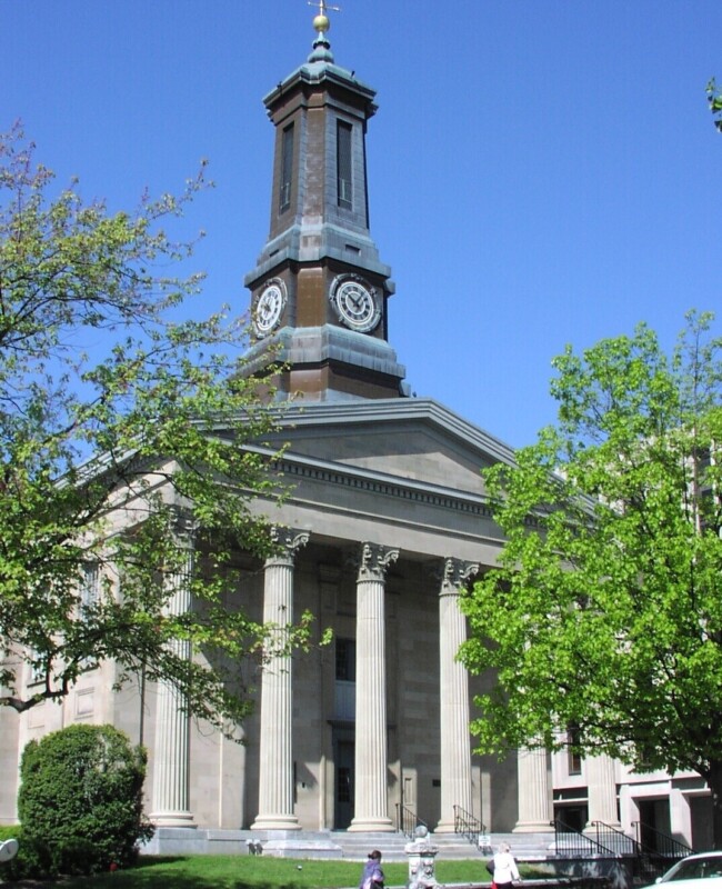 Greek Revival courthouse building with a tall steeple.