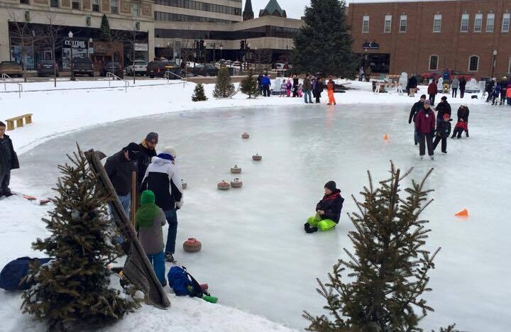 People skating on an outdoor ice rink.