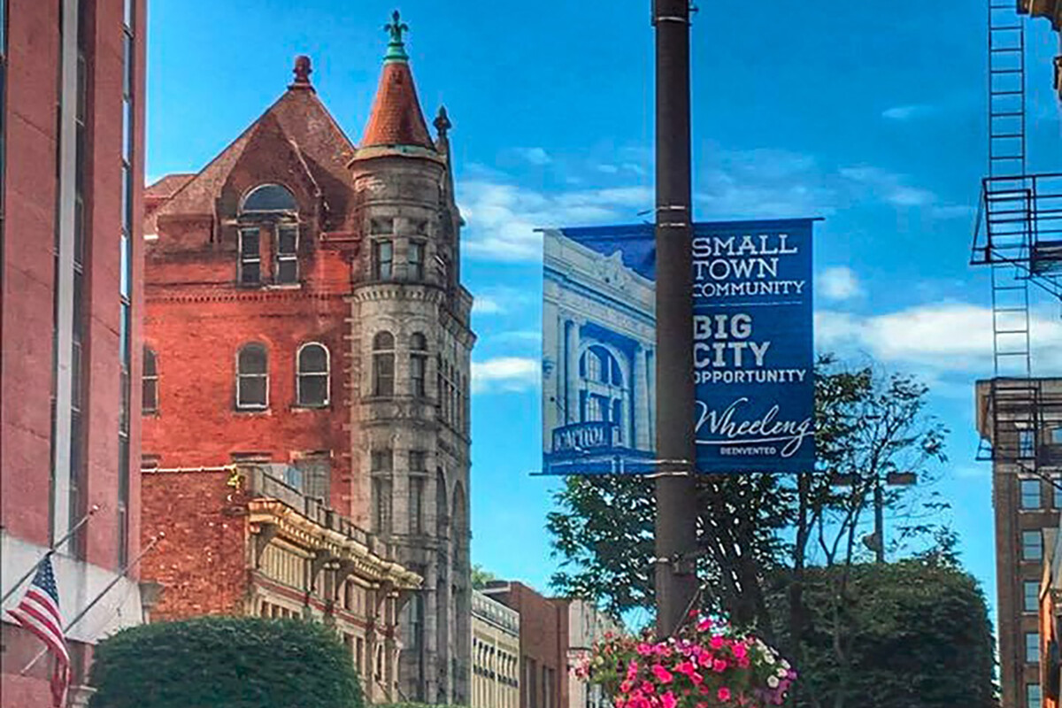 Blue street banners hang alongside a street pole.