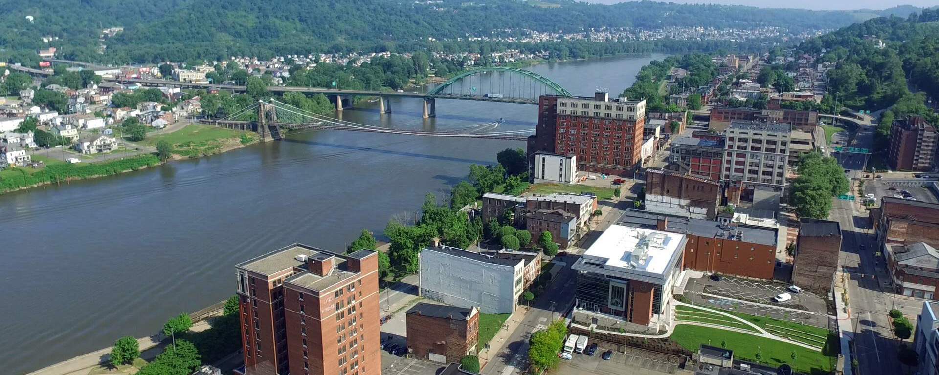 Aerial view of downtown buildings along a riverfront.