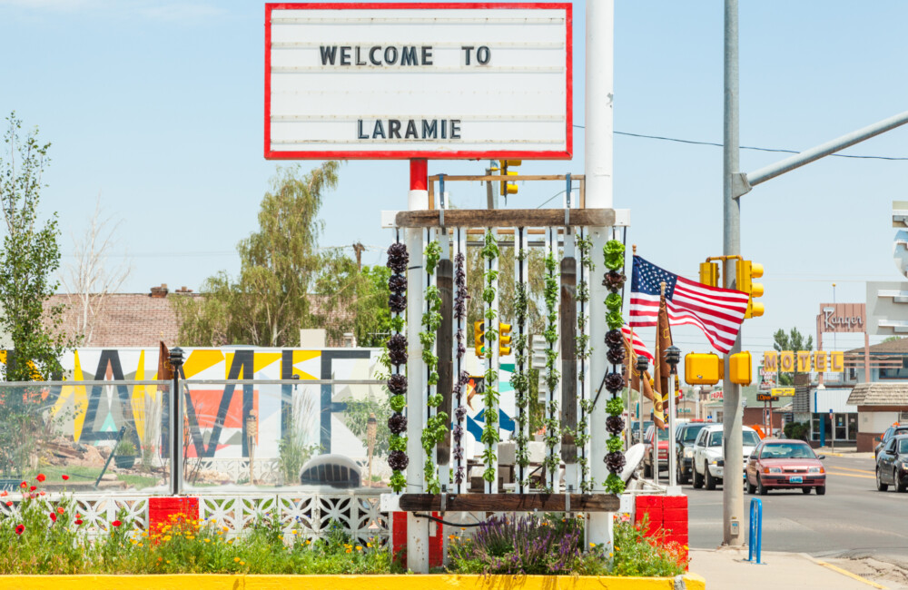 A vertical garden installed under a sign reading "Welcome to Laramie."