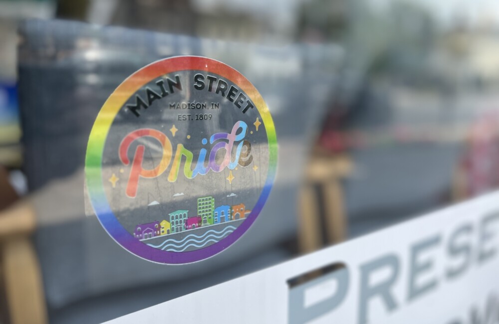 A rainbow-colored sticker reading "Main Street Pride" is displayed on a window.