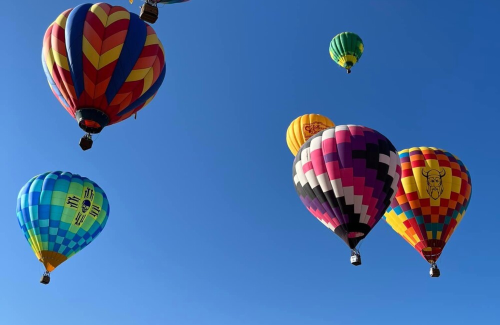 A dozen hot air balloons lifting off in Raton, New Mexico
