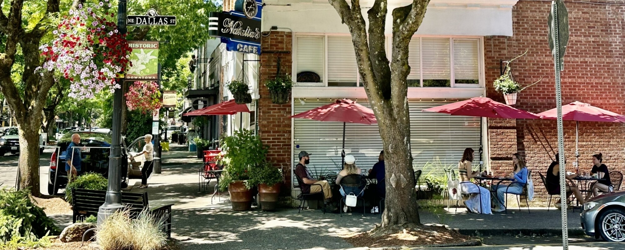 People sit outside at a corner cafe in downtown Camas, Washington.