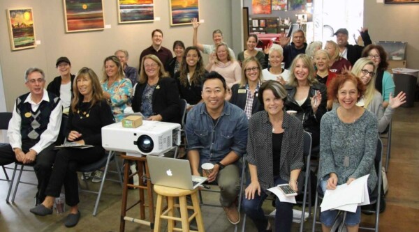 Community members sitting at a Main Street meeting in Carlsbad, California.