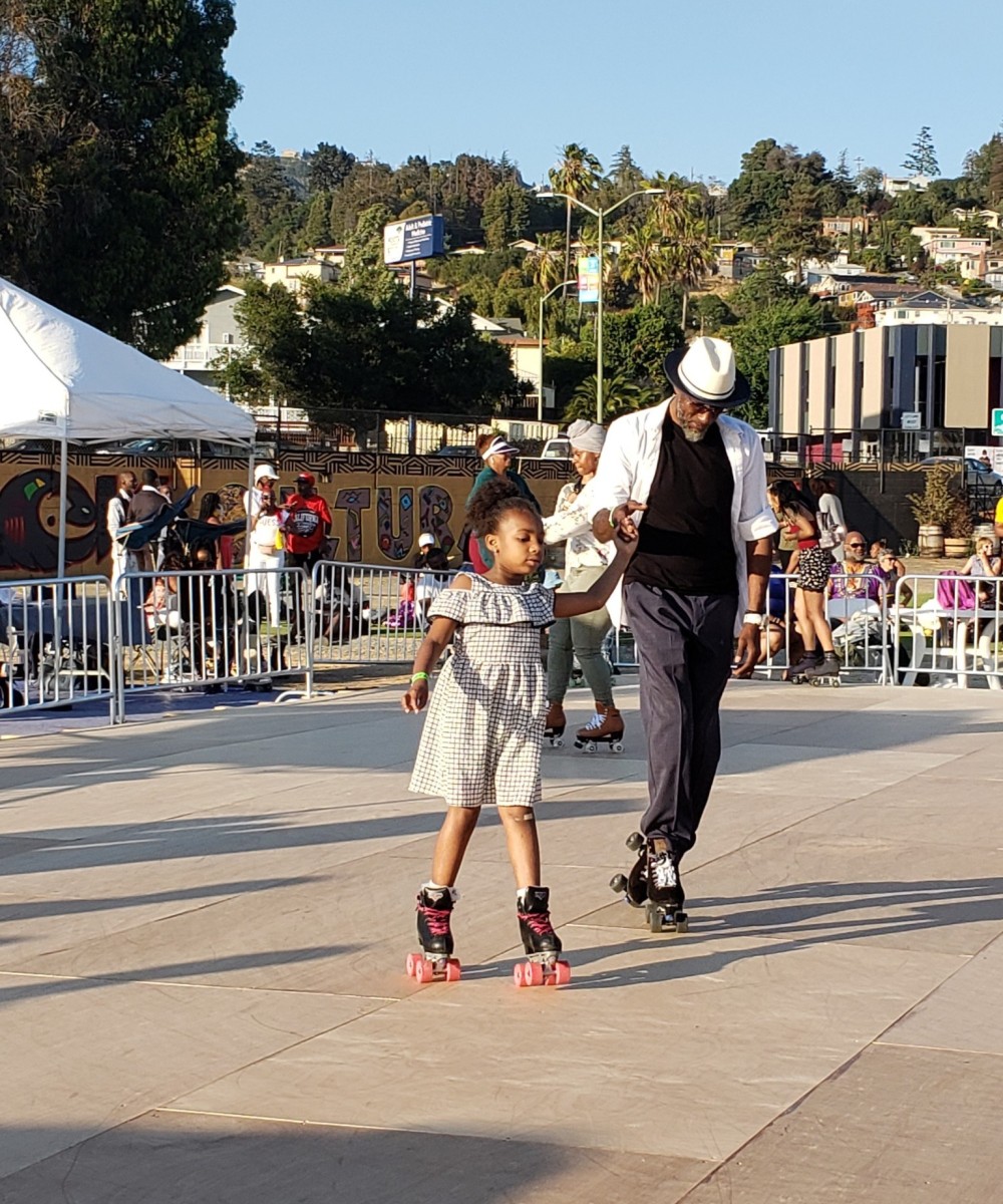 Man and Girl Roller Skating - Black Cultural Zone