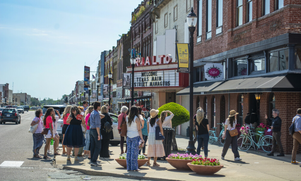 A group of people look at buildings.