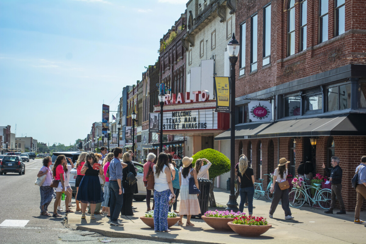 A group of people look at buildings.