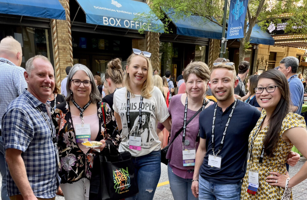 Six people pose for a group photo.