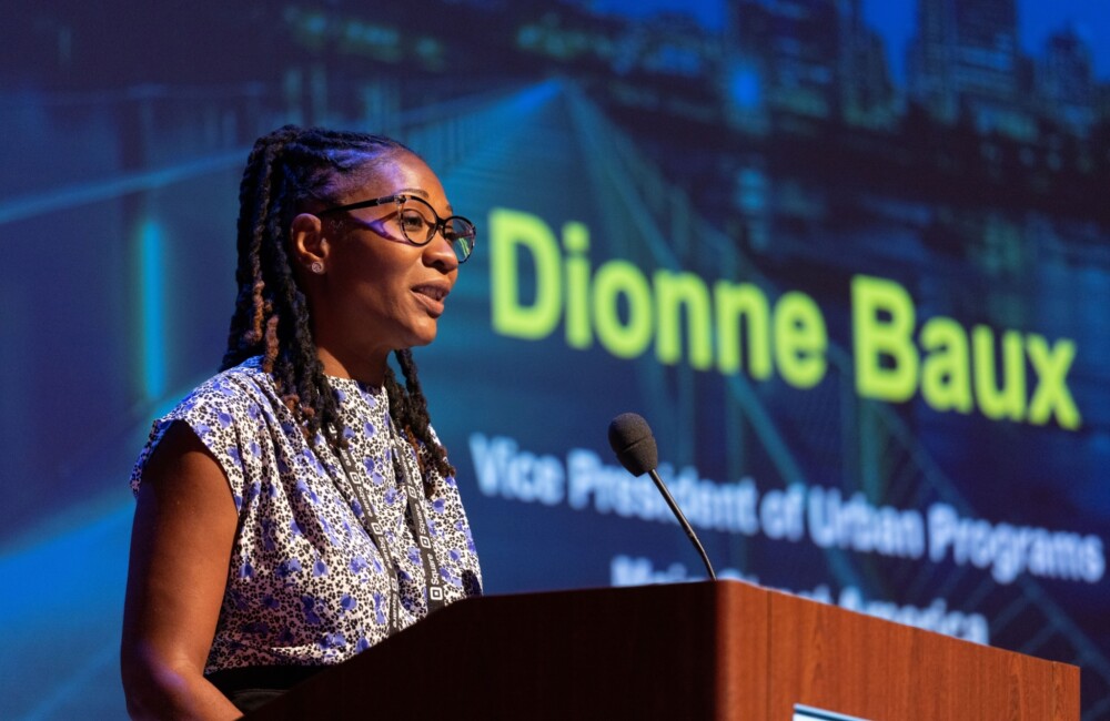 A woman speaks from behind a podium.