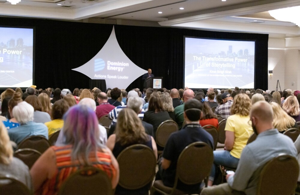 An audience listens to a speaker.