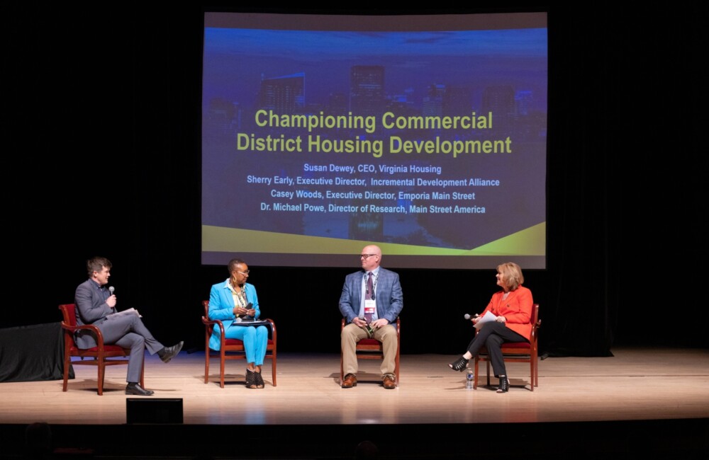 A panel of four people on stage.