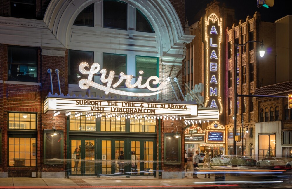 Marquees of the Lyric and Alabama Theatres shine bright at night.