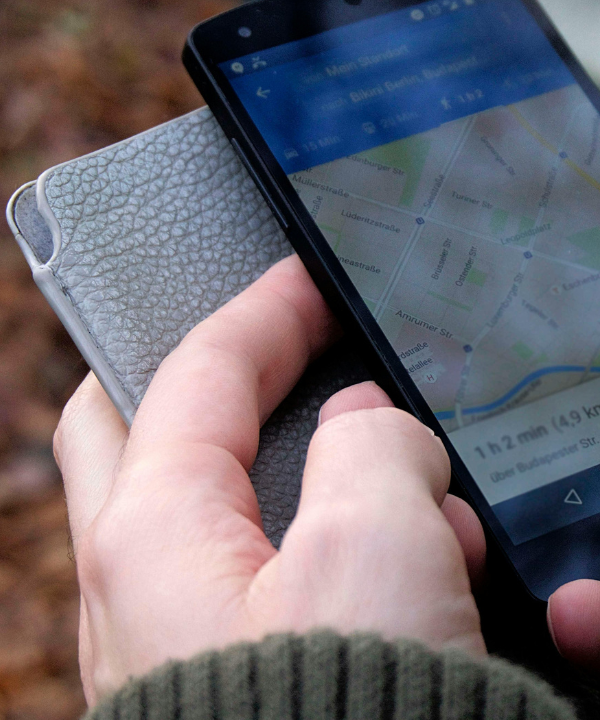 Hands holding phone that has Google Maps pulled up.