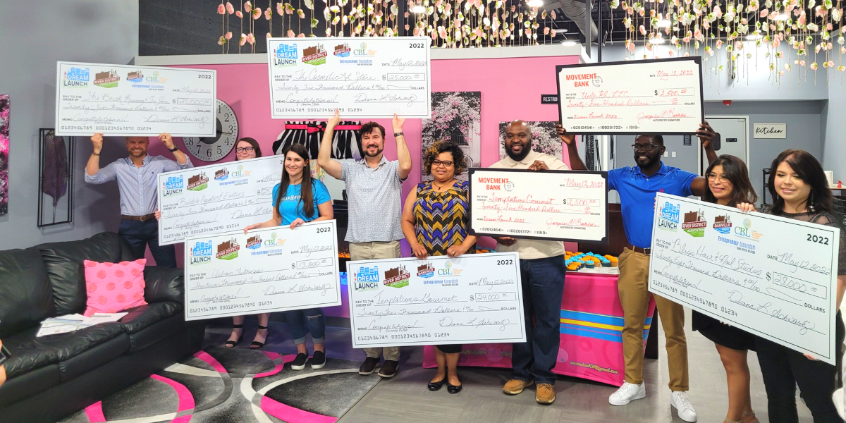 Grant recipients holding large award checks