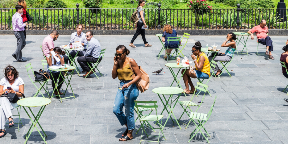 People sitting at tables at an outdoor downtown patio