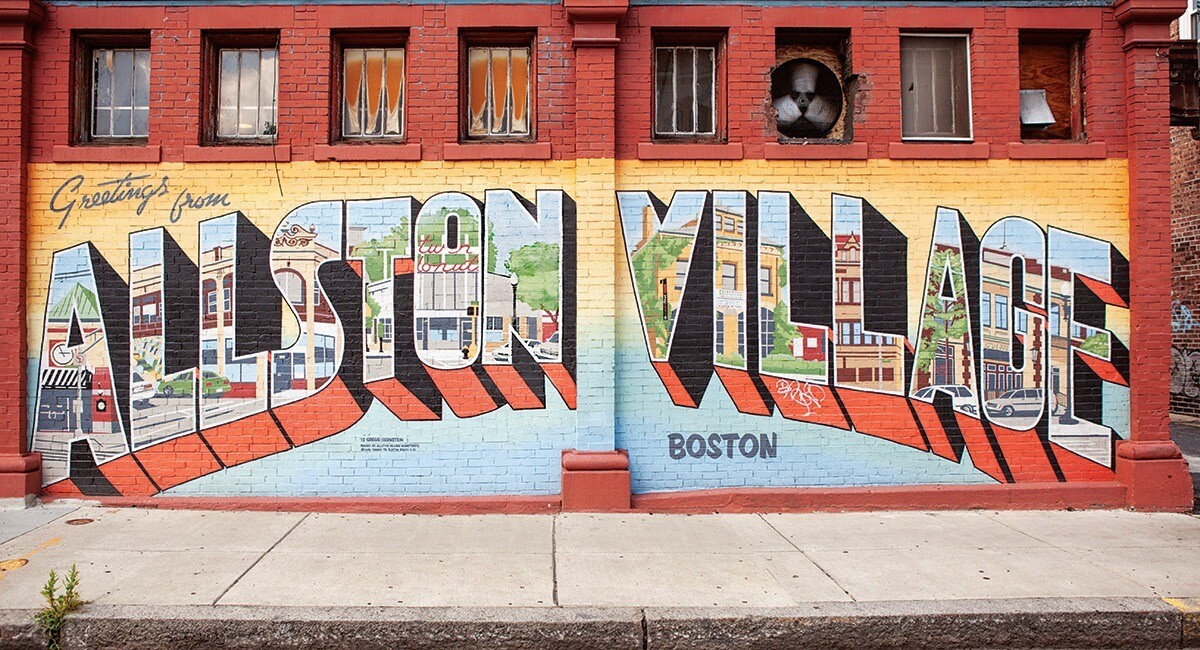 A mural with the words "Greetings from Allston Village"