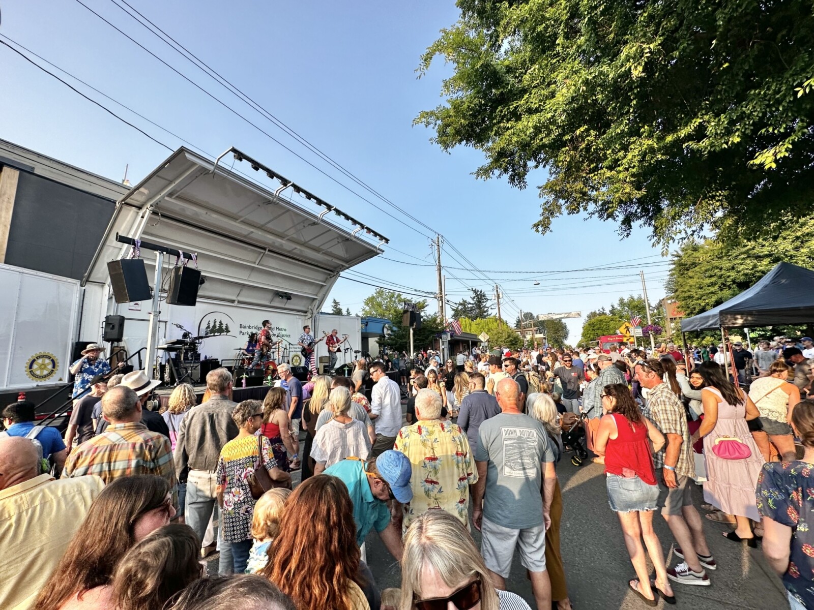 People listen to live music at an outdoor concert in Bainbridge, Washington