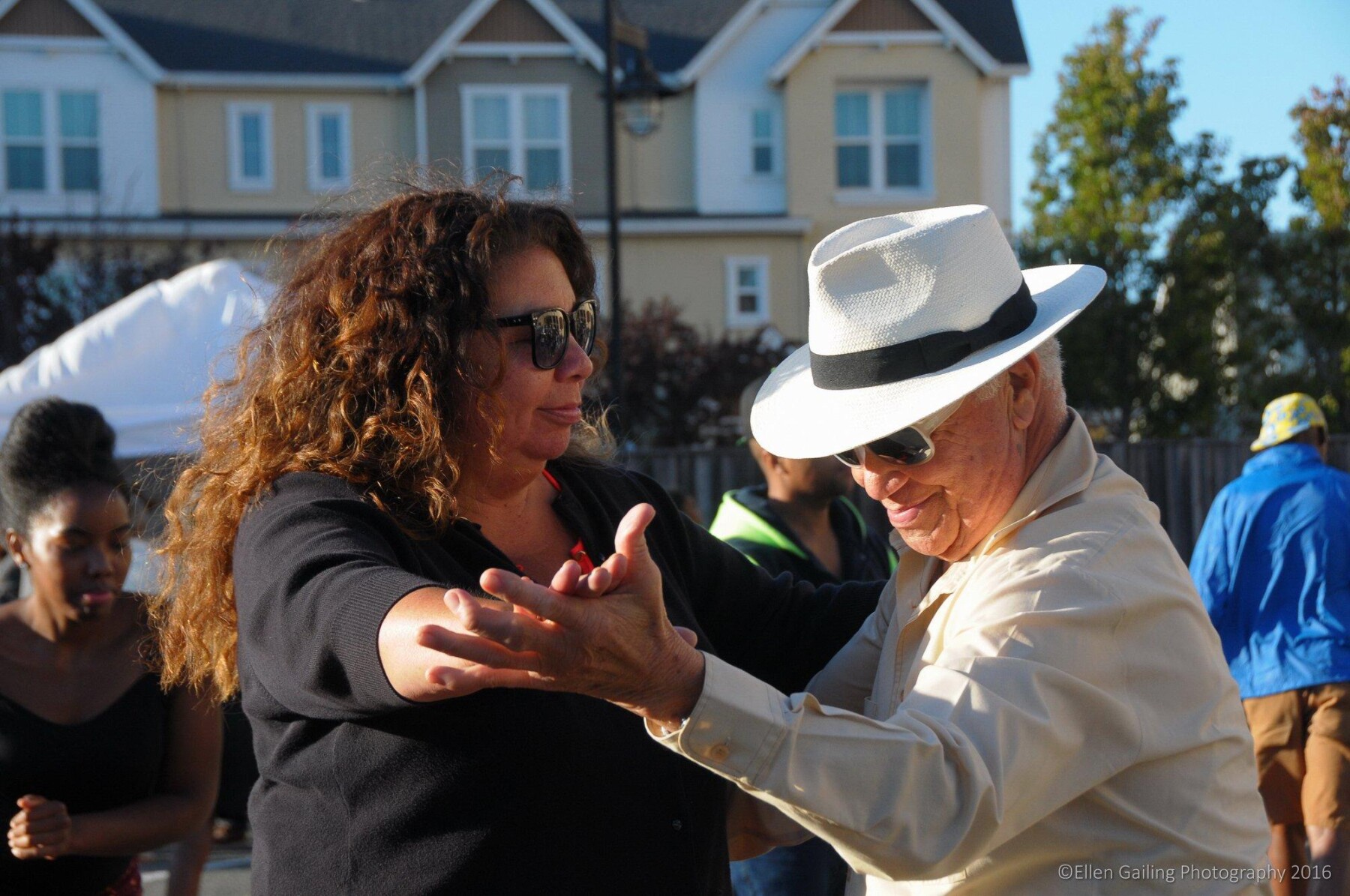 Two people dancing at an outdoor event