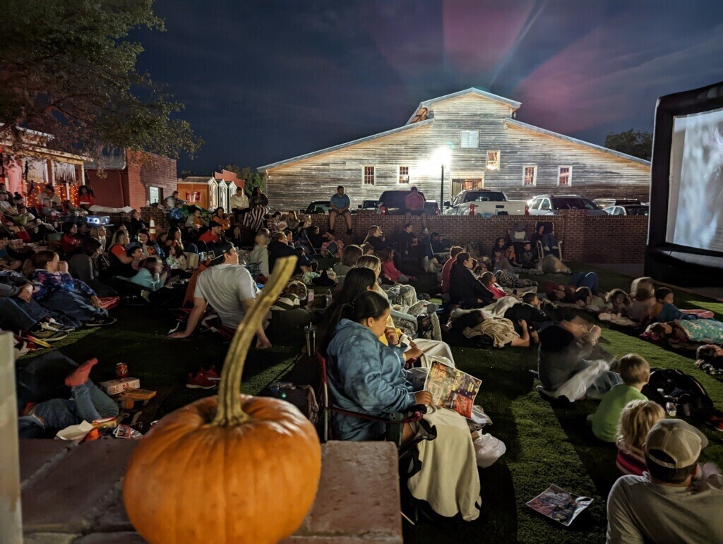 People attending a Halloween screening of an outdoor movie