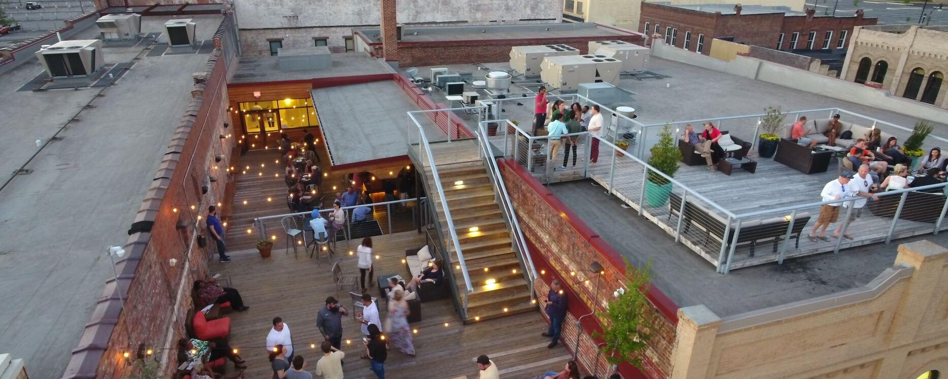 Overhead view of people socializing at the Dispensary, Downtown Florence's first rooftop entertainment facility.