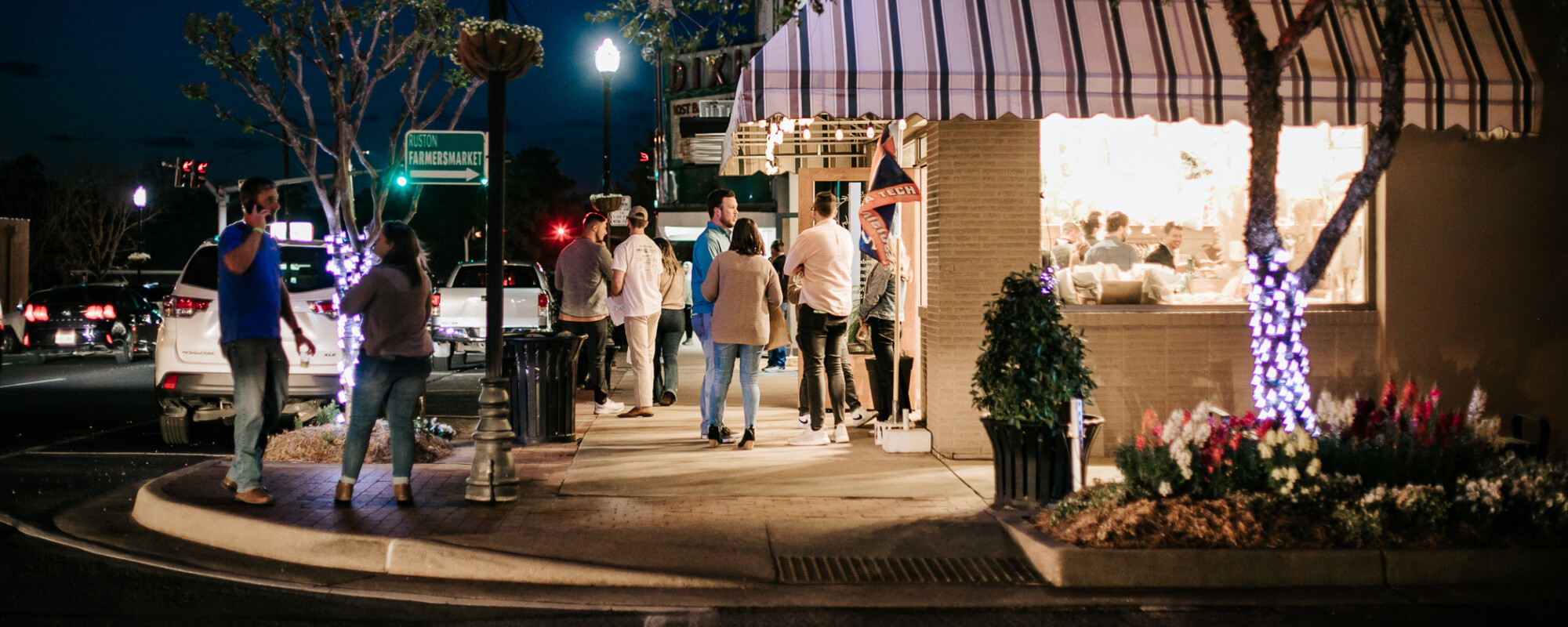 People attending a nighttime event in downtown Ruston