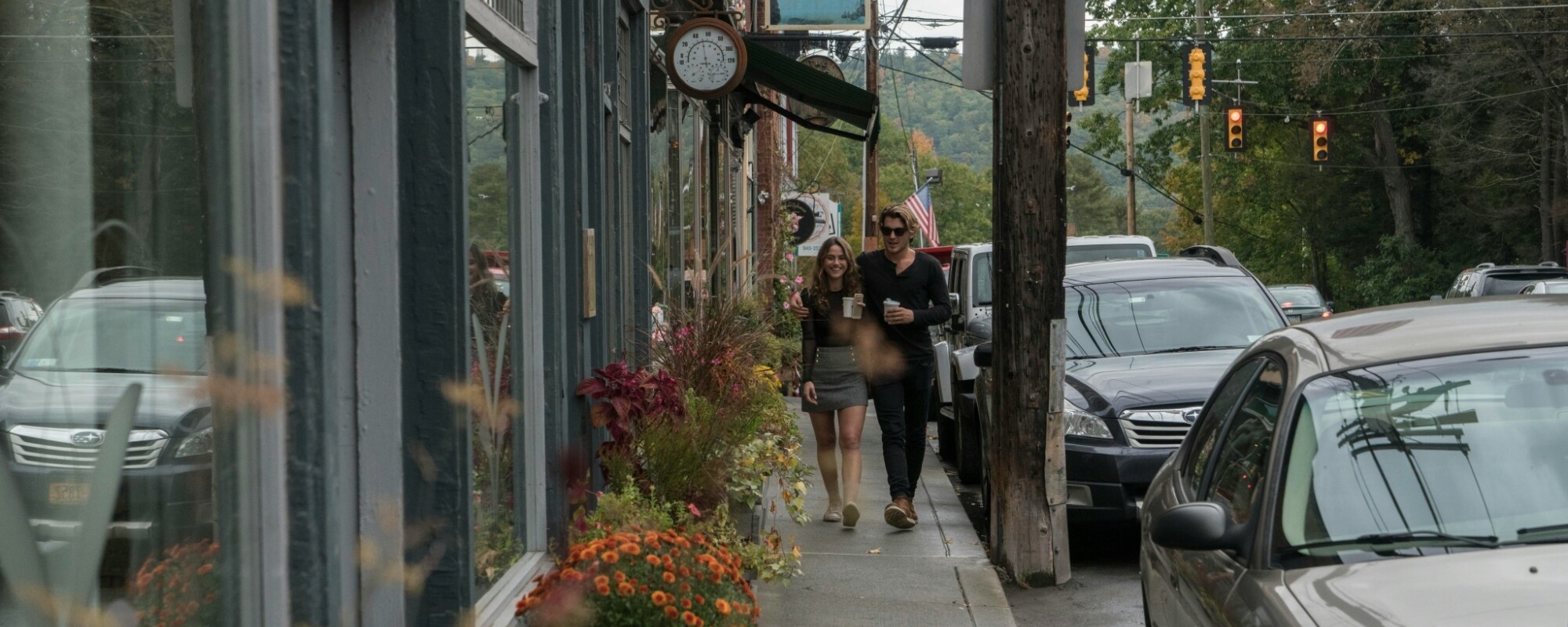 Two people walking down the sidewalk in Narrowsburg, New York
