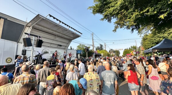 People listen to live music at an outdoor concert in Bainbridge, Washington