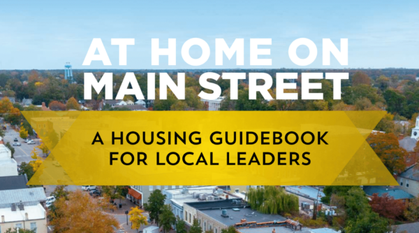 Cover of Housing Guidebook featuring aerial view of downtown