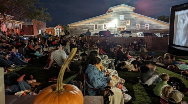 People attending a Halloween screening of an outdoor movie