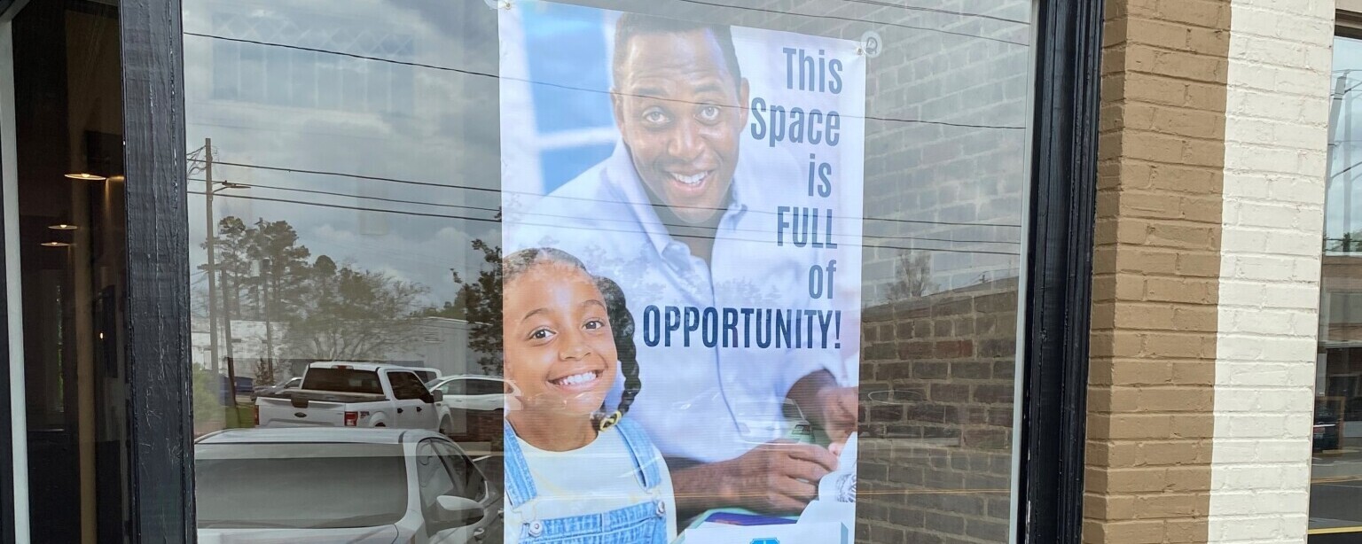 A sign promotes the availability of a vacant commercial space.