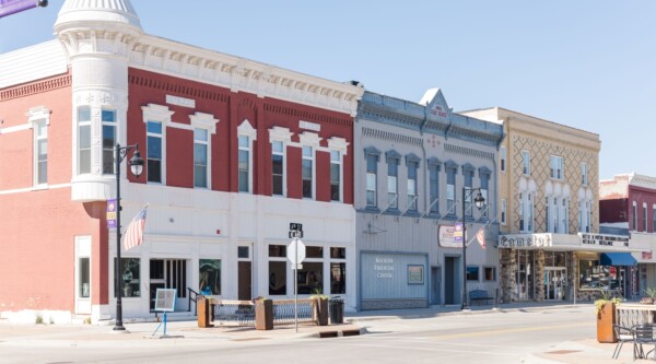 Historic buildings line a commercial district street.