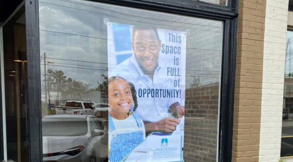 A sign promotes the availability of a vacant commercial space.