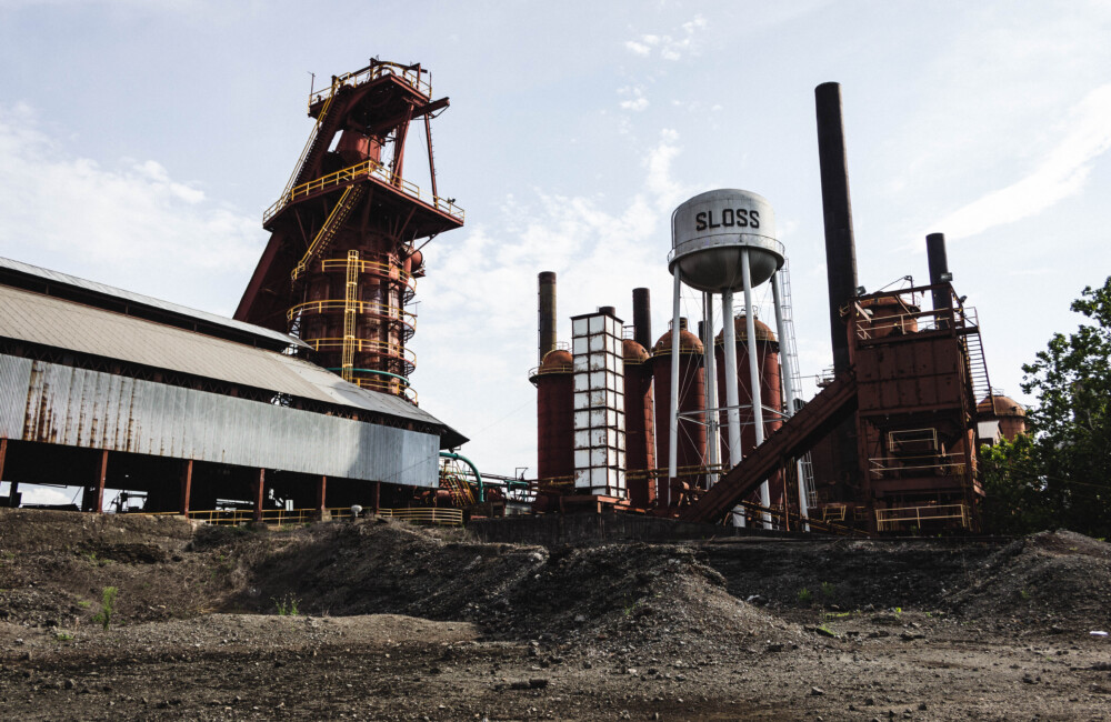 Sloss Furnaces exterior stacks with gravel piles in foreground.