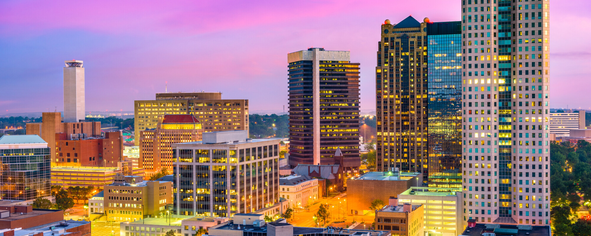 Illuminated aerial view of Birmingham skyline at night.