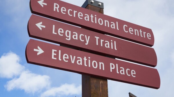 Wayfinding signage reading, "Recreational Centre," "Legacy Trail," "Elevation Place."