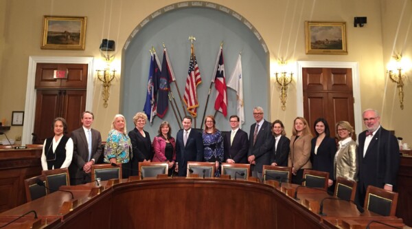 Group of officials stand in government office. Jann Mirkov and Yvonne Knowles (3rd and 4th from the left) and other park advocates with Terry Camp, staff to the House Natural Resources Committee. Photo credit: Pam Bowman, Director of Public Lands Policy at the National Trust for Historic Preservation.