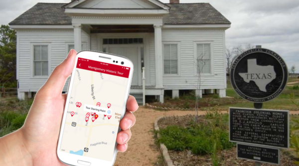 In front of historic home, hand holding iphone with a map open.