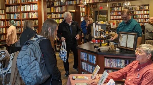 People browse shelves in a small used bookstore