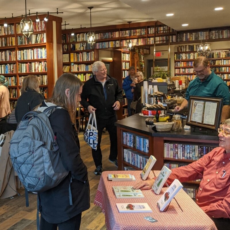 People browse shelves in a small used bookstore