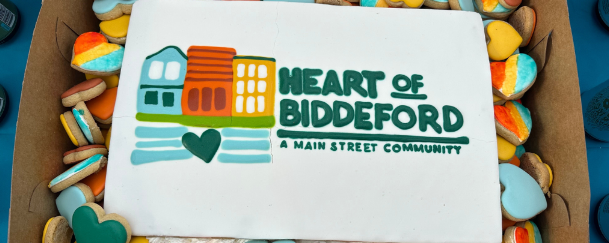 A cake decorated with the new Heart of Biddeford logo