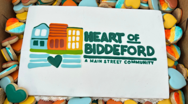 A cake decorated with the new Heart of Biddeford logo